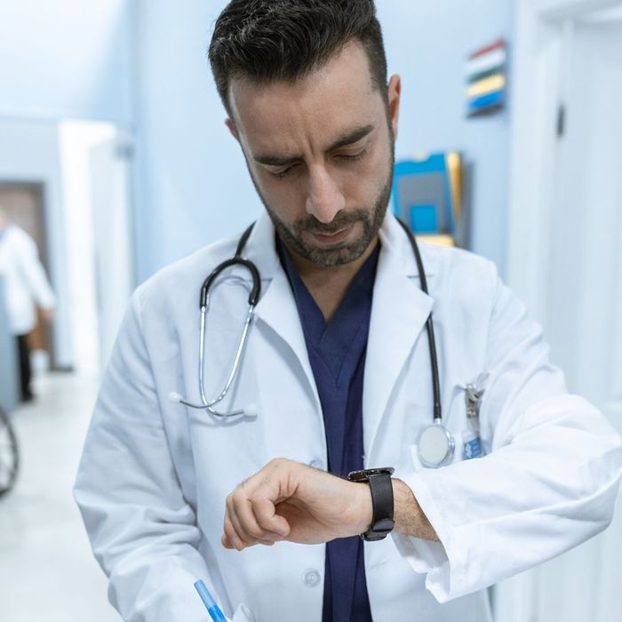 A doctor looking at his watch