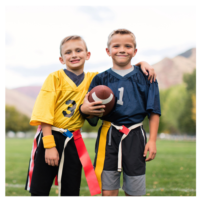 Two boys playing flag football