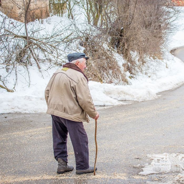 A old man walking in the winter