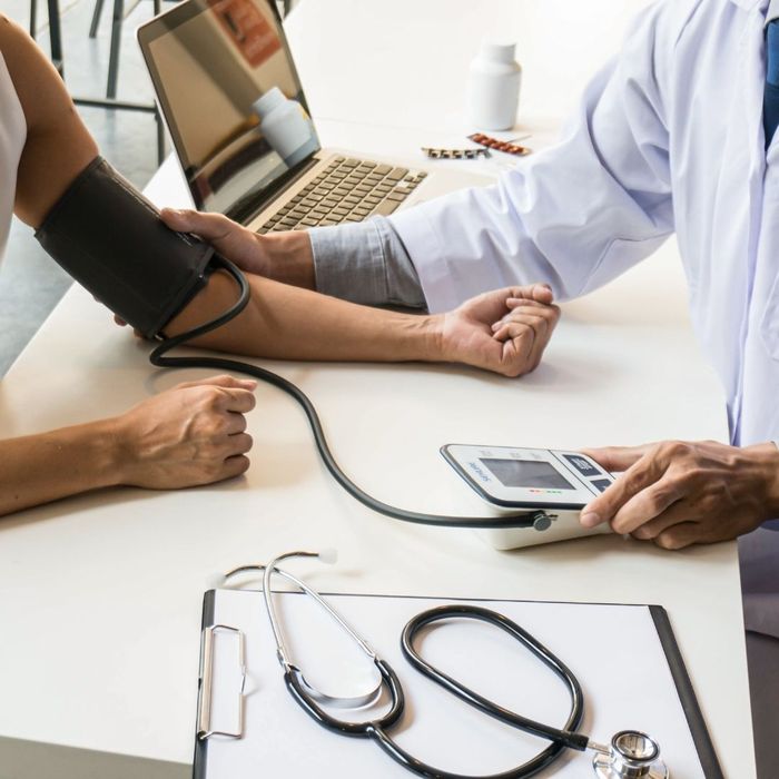 Doctor taking a patients blood pressure