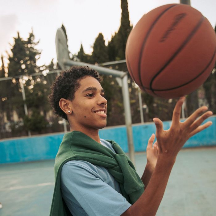 A kid spinning a basketball on his finger