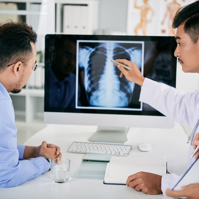 doctor showing x-ray to patient