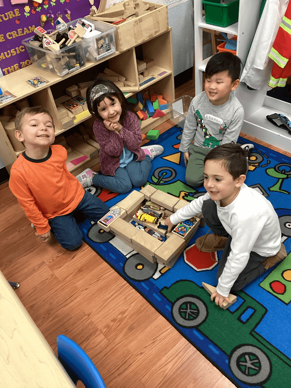 group of children in preschool playing with toys group of children in preschool playing with toys