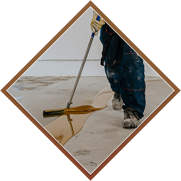 Flooring expert applying an epoxy coating to concrete