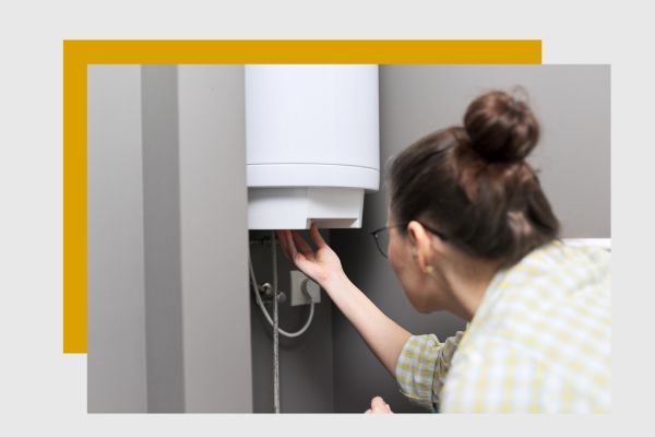 woman adjusting tankless water heater