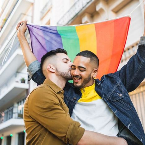 A man kissing his boyfriend on the cheek