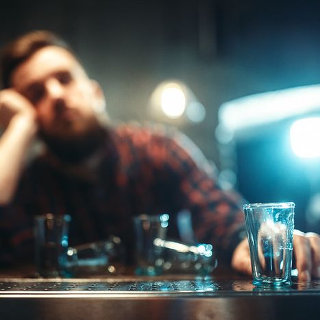 man drinking at a bar alone