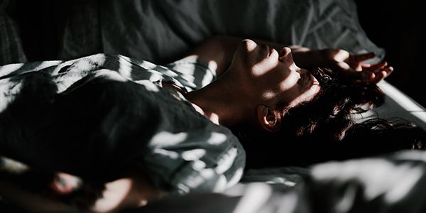 woman laying awake in a bed