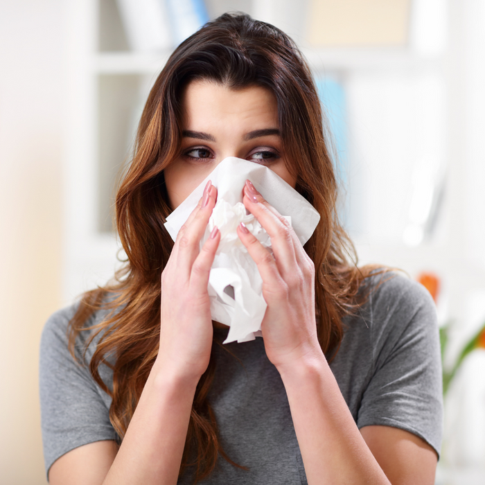 A women blowing her nose