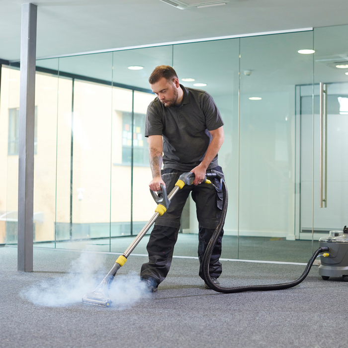 A carpet cleaner steaming a carpet