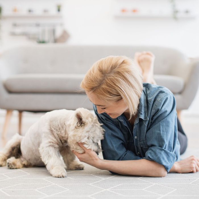 woman and her dog on a carpet