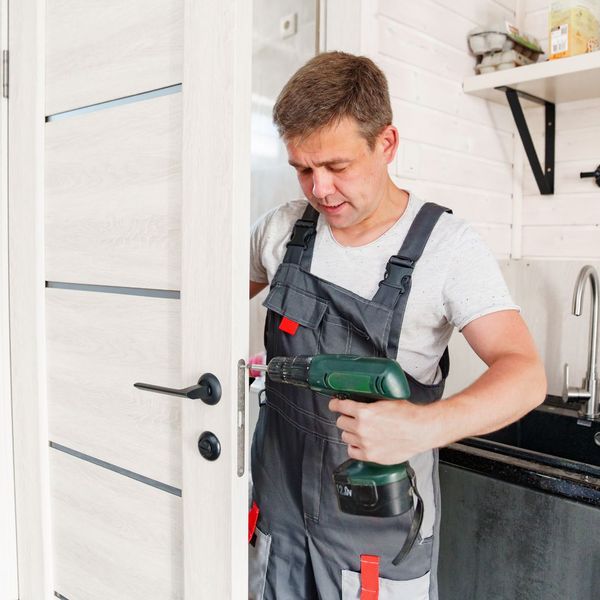 handyman repairing door