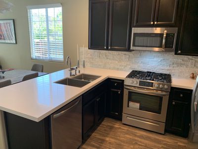 new-stainless-appliances-quartz-counters-and-laminate-floors-west-designs-full-service-k-b-designer-builder-img~bc81b4f40e85188d_8-6173-1-3fb91e0.jpg