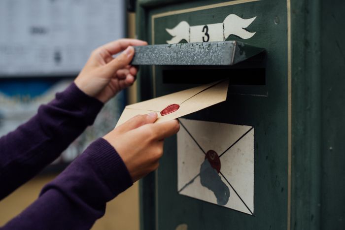 posting-letter-to-old-postbox-on-street-2023-11-27-05-30-49-utc.jpg