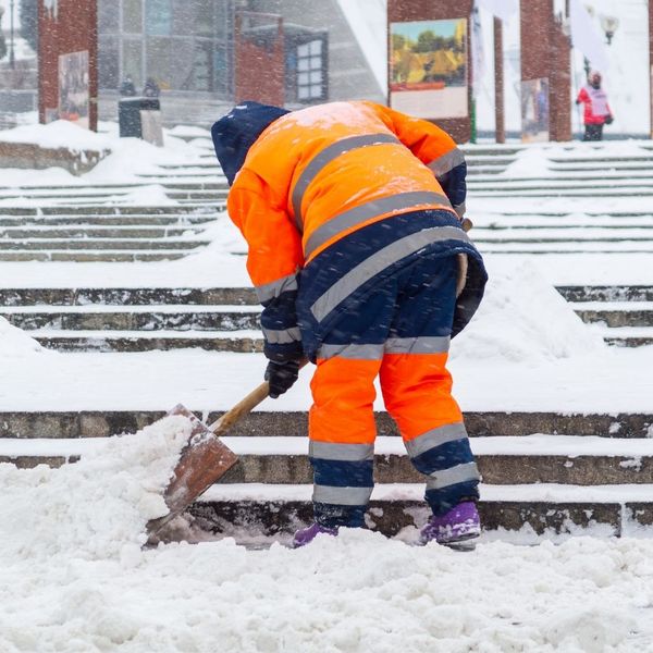 person shoveling snow on steps