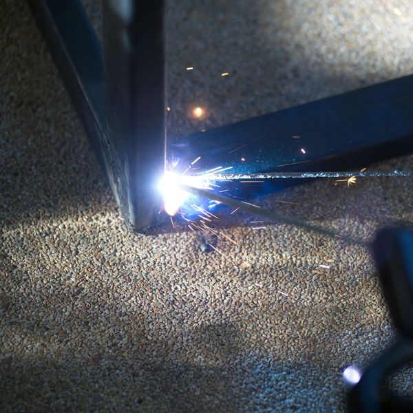 Welder carefully controlling the arc, showing consistent bead.