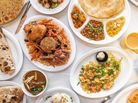 Table full of authentic Pakistani breakfast items. 