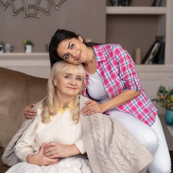 Image of a woman hugging an aging mother