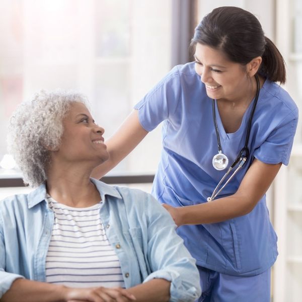 senior care nurse with patient