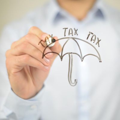man drawing an umbrella with the word tax on glass