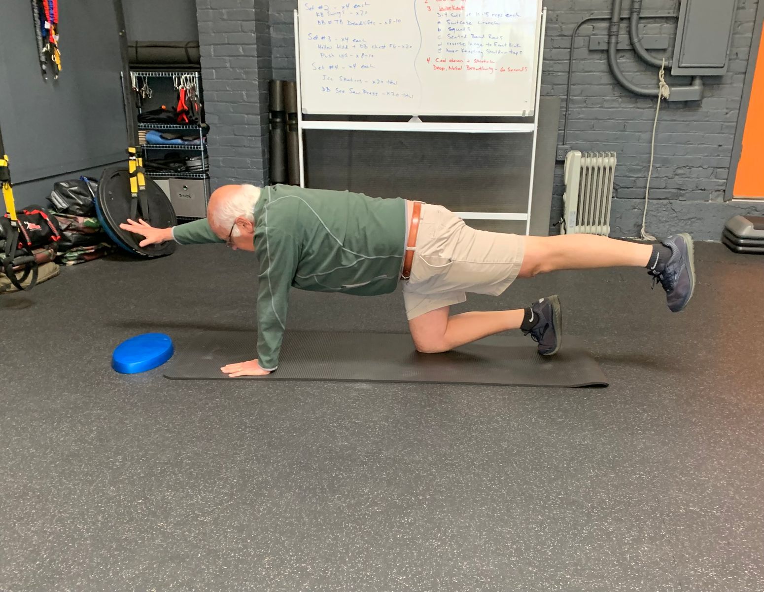 Photo of a man working out on a matt