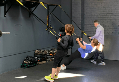 Two woman working out with tension bands