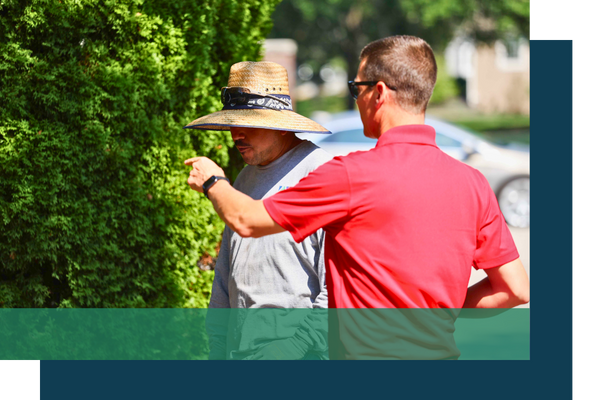 Man in red talking with a landscaper