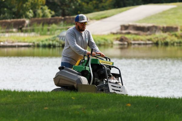 Landscaper mowing grass
