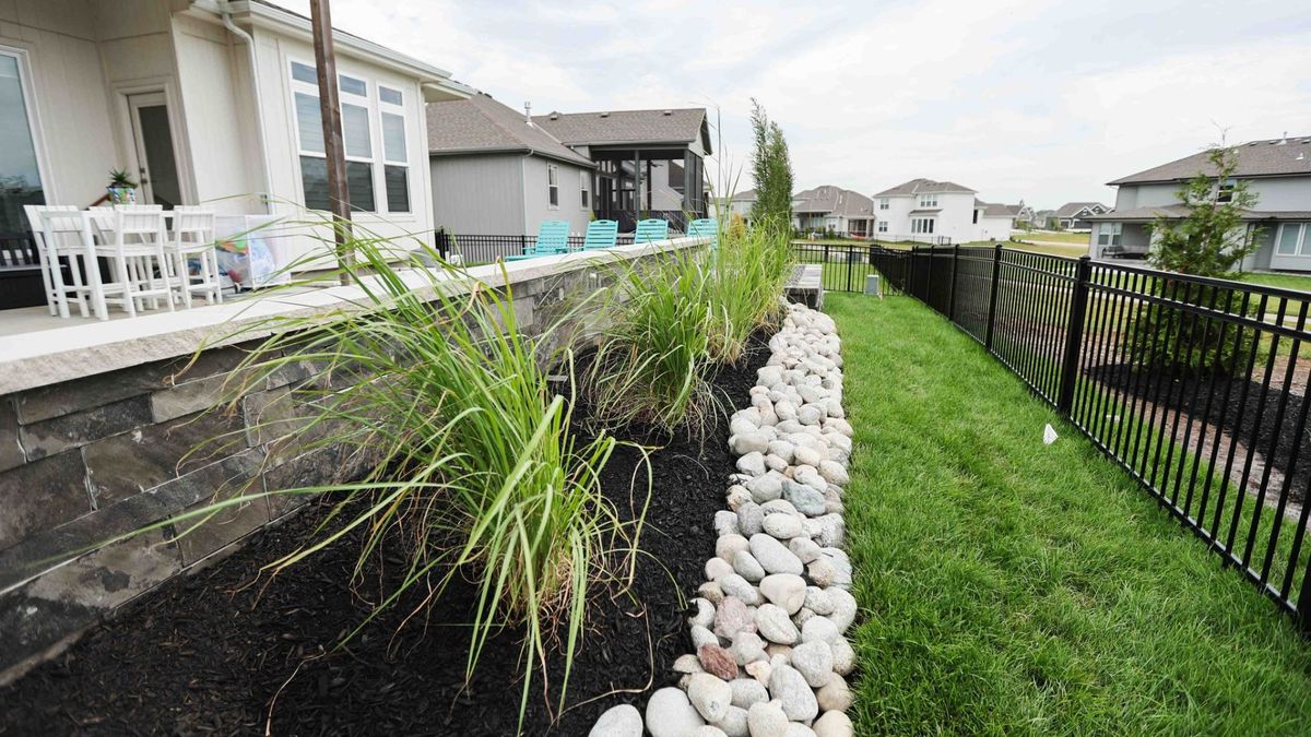 Landscaped garden beds along patio