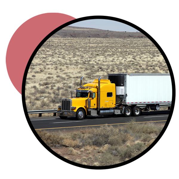  An image of a semi truck driving on a desert highway to reach its destination.