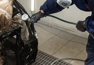 Photo of a car frame being painted