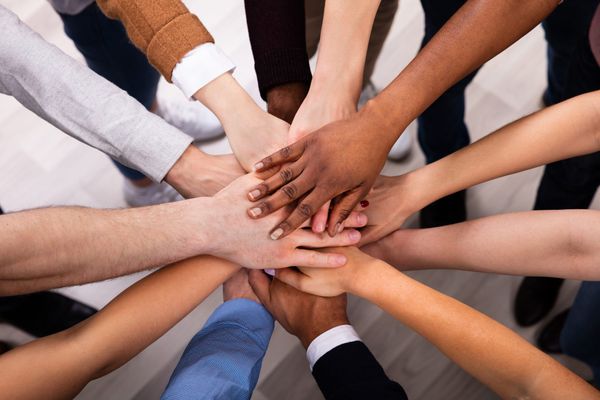 Diverse-People-Stacking-Hand-Together-1152125129_8194x5463-scaled.jpeg