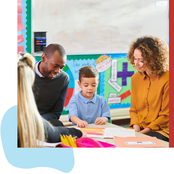 parents smiling as a teacher helps their child