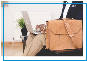 business man on laptop with briefcase