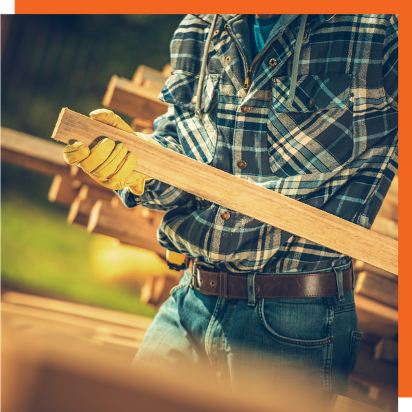 A worker holding a piece of wood