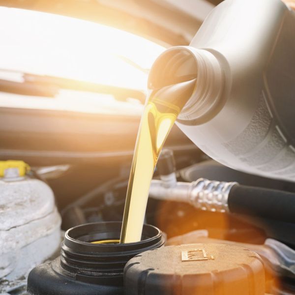 Synthetic oil being poured into a car. 