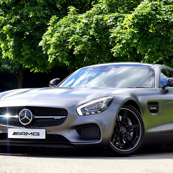 Silver Mercedes-benz Amg Gt Coupe Parked Beside Green Leaf Tree