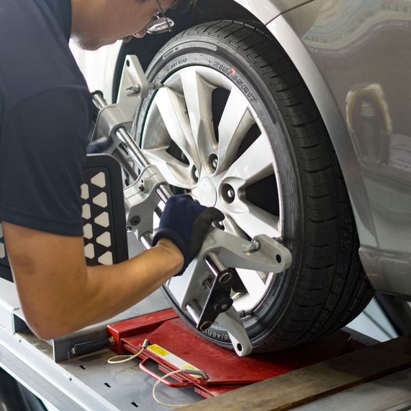 Auto technician performing a wheel alignment