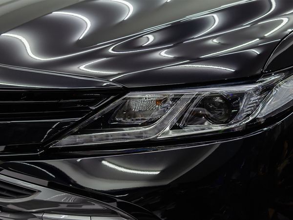 Detail shot of the hood of a shiny black car