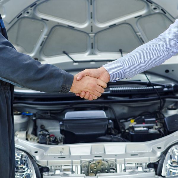 mechanic and client shaking hands