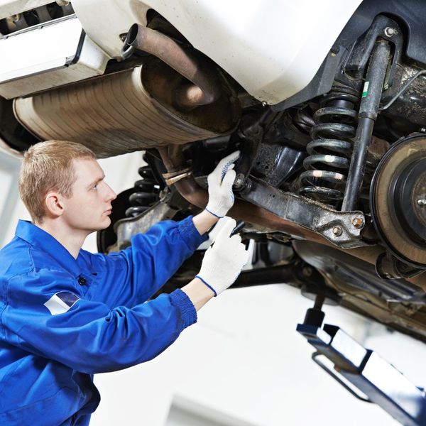a person working on a car suspension