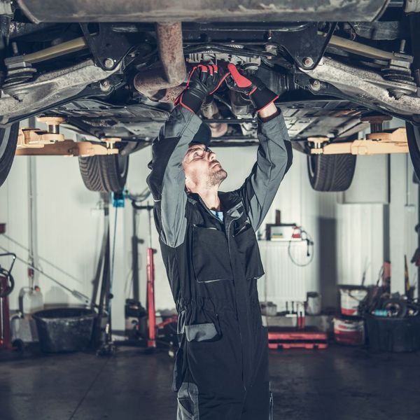 mechanic working under car