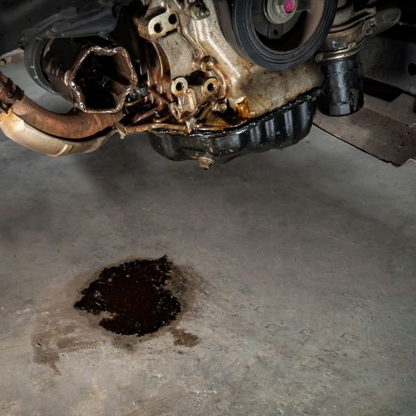 puddle of oil on the floor under an engine
