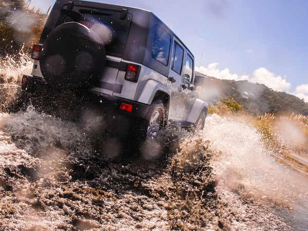 Jeep driving through muddy water