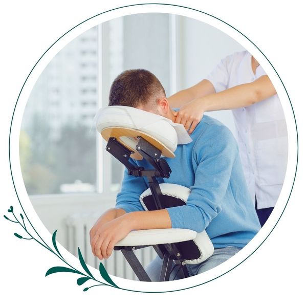 man getting chair massage while in office