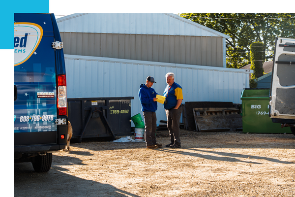 two plumbers discussing outside two plumbers discussing outside