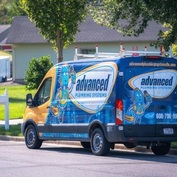 Branded Advanced Plumbing service van arriving at a customer's residential home.