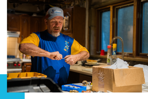plumber working on a kitchen sink