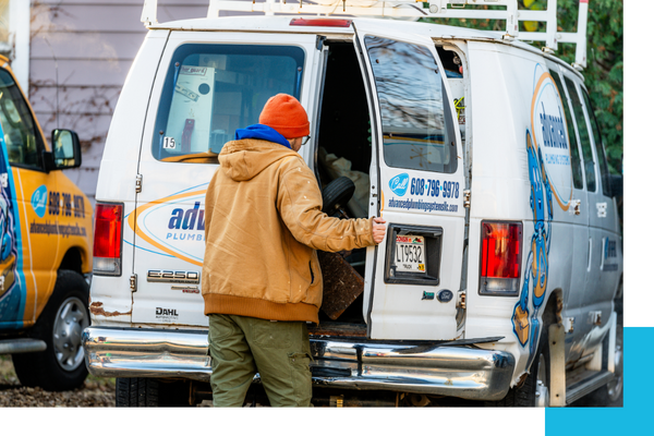Plumber getting equipment out of van