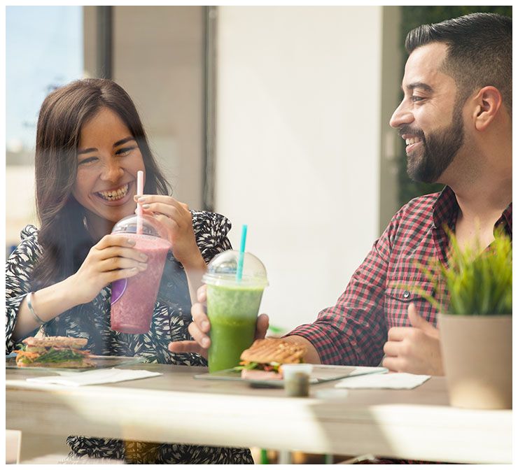 A couple talking and drinking smoothies